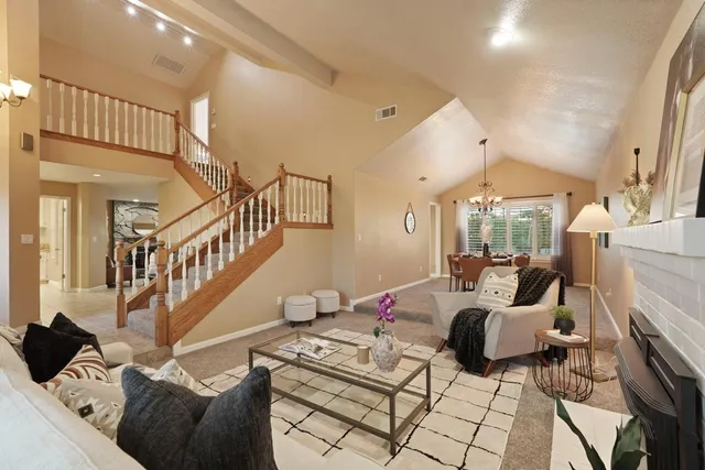 a living room with furniture fireplace and a large window