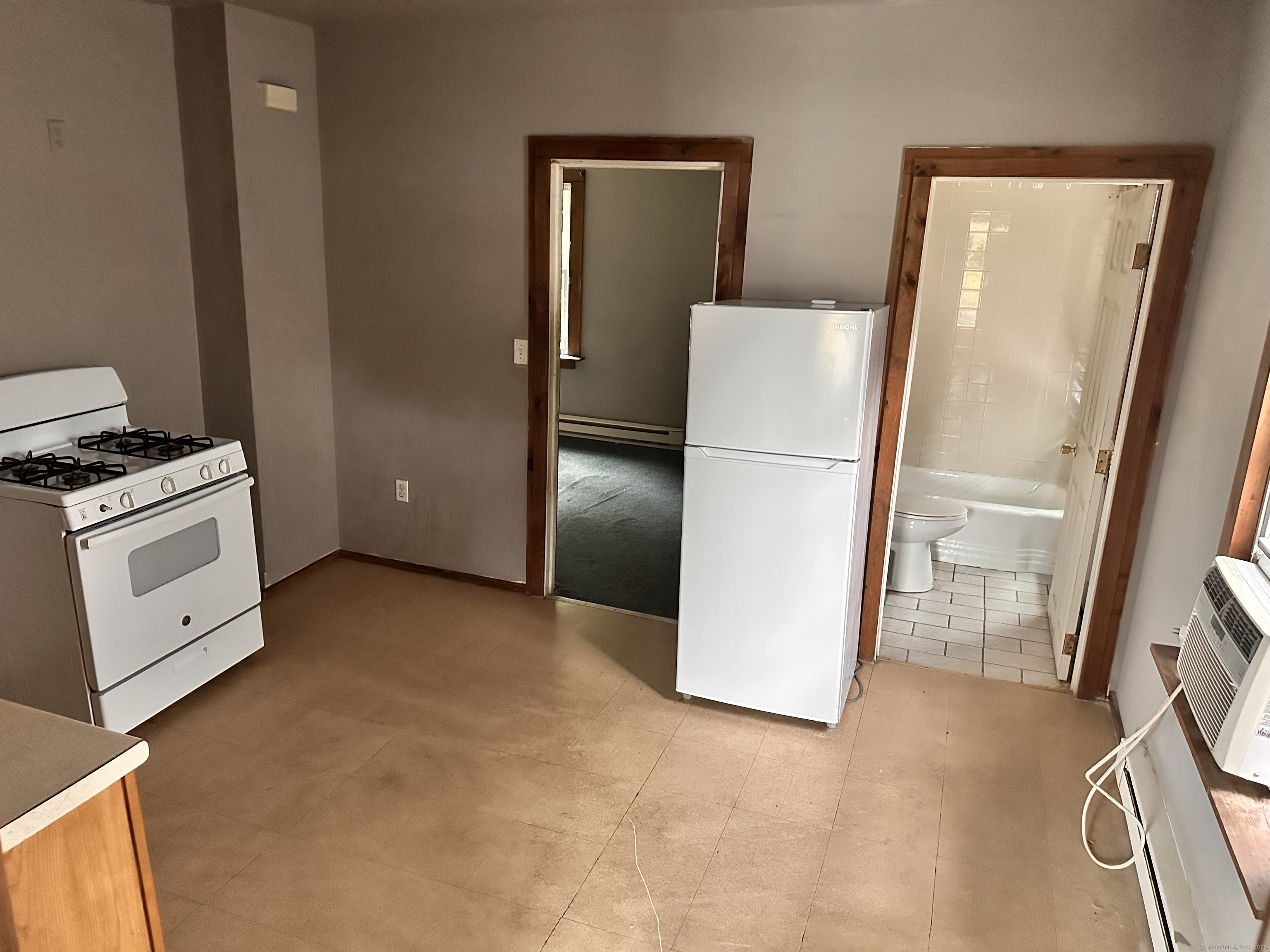 122 Willow Street Meriden, CT 06450 - Photo 5 of 13 a view of a kitchen with a stove fridge and wooden floor