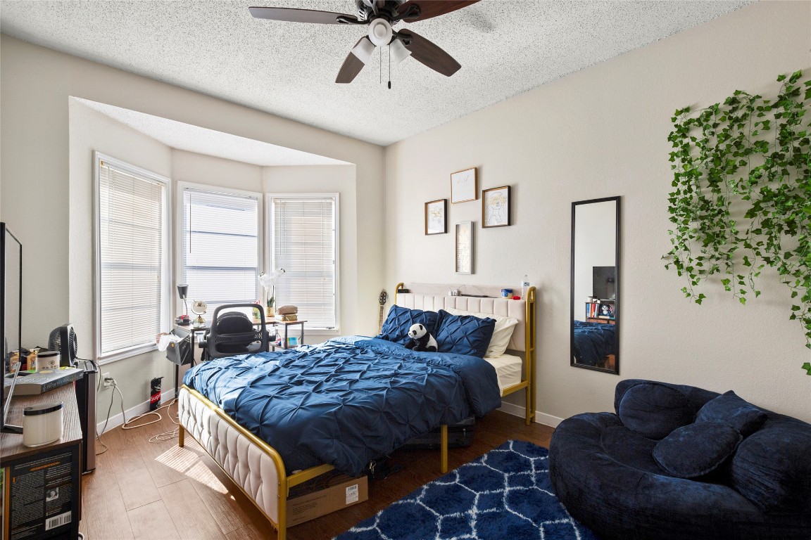 915 West 23rd Street, Unit 208 Austin, TX 78705 - Photo 2 of 16 a bedroom with bed couch and window