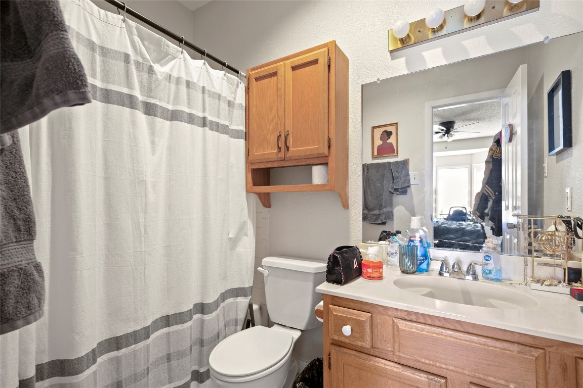 915 West 23rd Street, Unit 208 Austin, TX 78705 - Photo 4 of 16 a bathroom with a sink a toilet and shower curtain