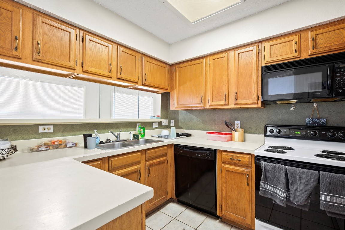 915 West 23rd Street, Unit 208 Austin, TX 78705 - Photo 9 of 16 a kitchen with stainless steel appliances granite countertop a sink stove and cabinets