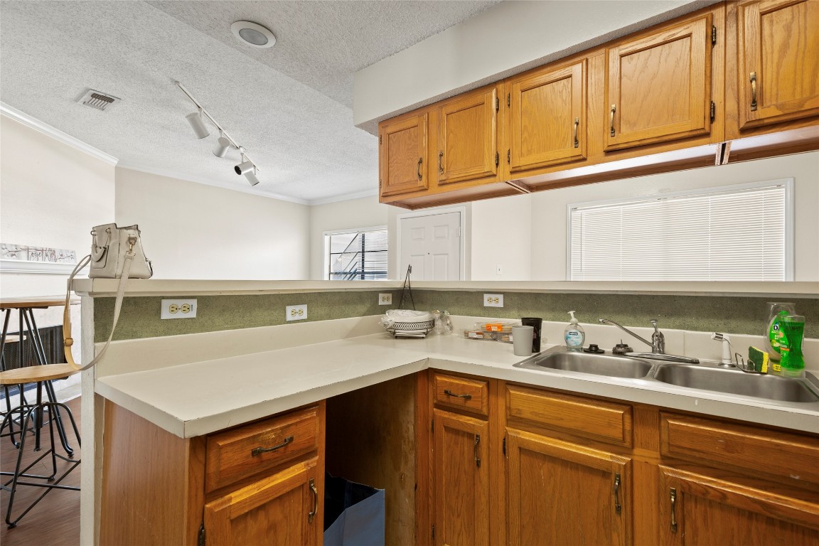915 West 23rd Street, Unit 208 Austin, TX 78705 - Photo 10 of 16 a kitchen with a sink cabinets and window