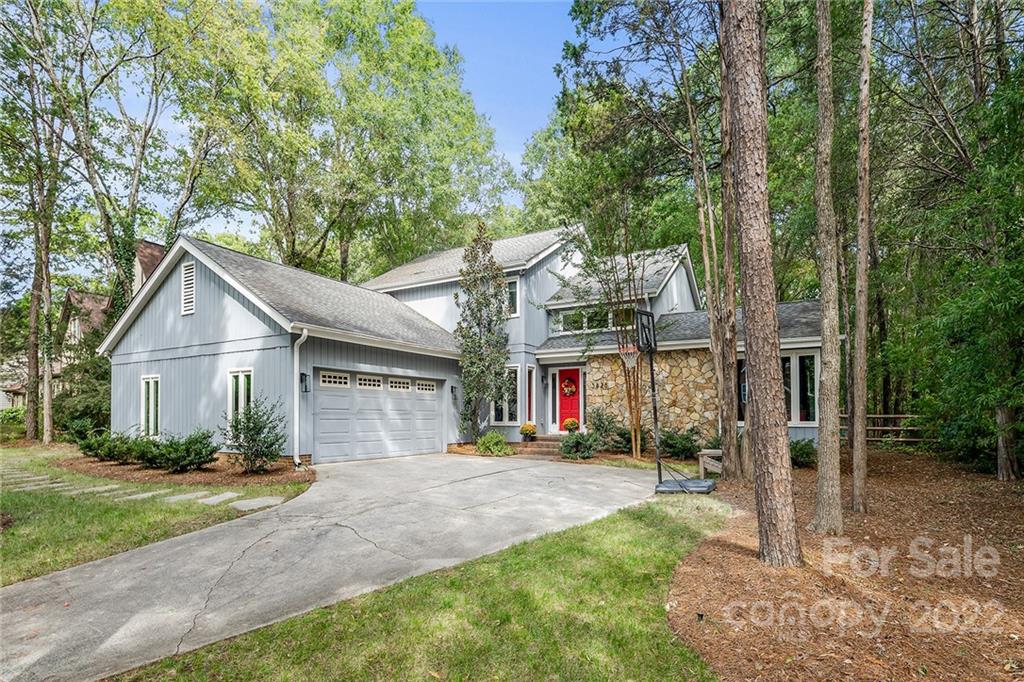 5428 Hillingdon Road Charlotte, NC 28226 - Photo 1 of 36 a view of a white house with a big yard and large tree
