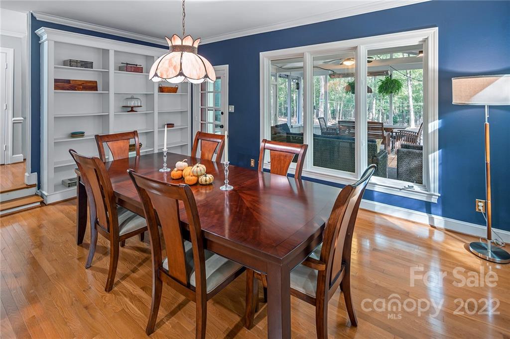 5428 Hillingdon Road Charlotte, NC 28226 - Photo 18 of 36 a dining room with furniture large windows and a chandelier