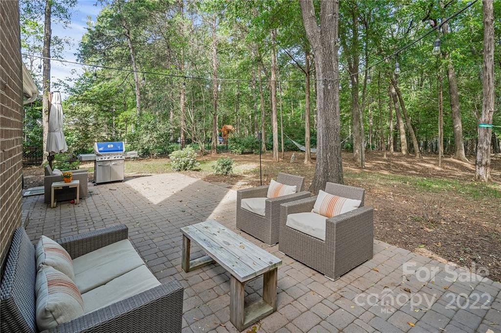 5428 Hillingdon Road Charlotte, NC 28226 - Photo 33 of 36 a view of a patio with couches and a table and chairs with wooden fence