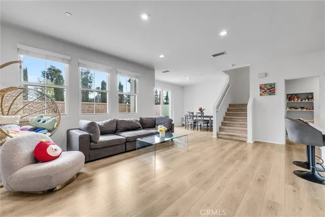 a living room with furniture and wooden floor