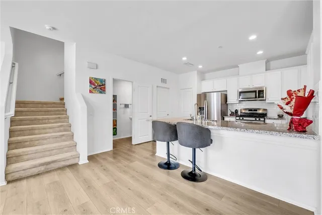 a view of kitchen with furniture and wooden floor