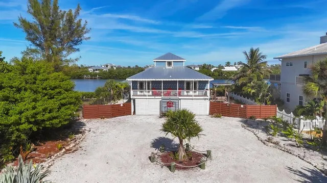 an aerial view of a house with a lake view