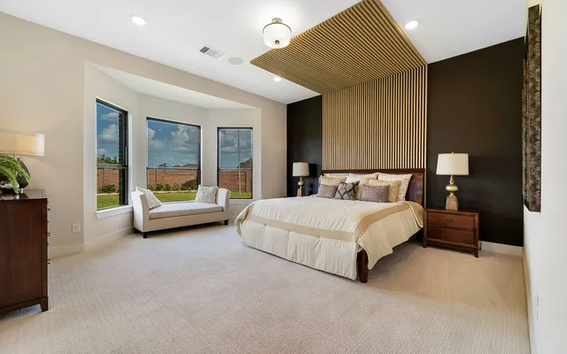 a bed room with a bed and a chair