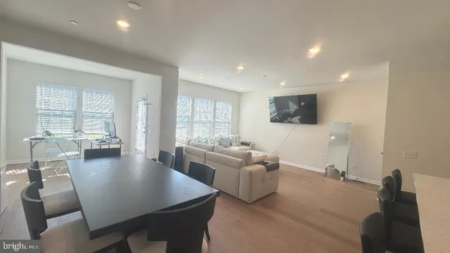 a kitchen with a sink a counter top space and living room area