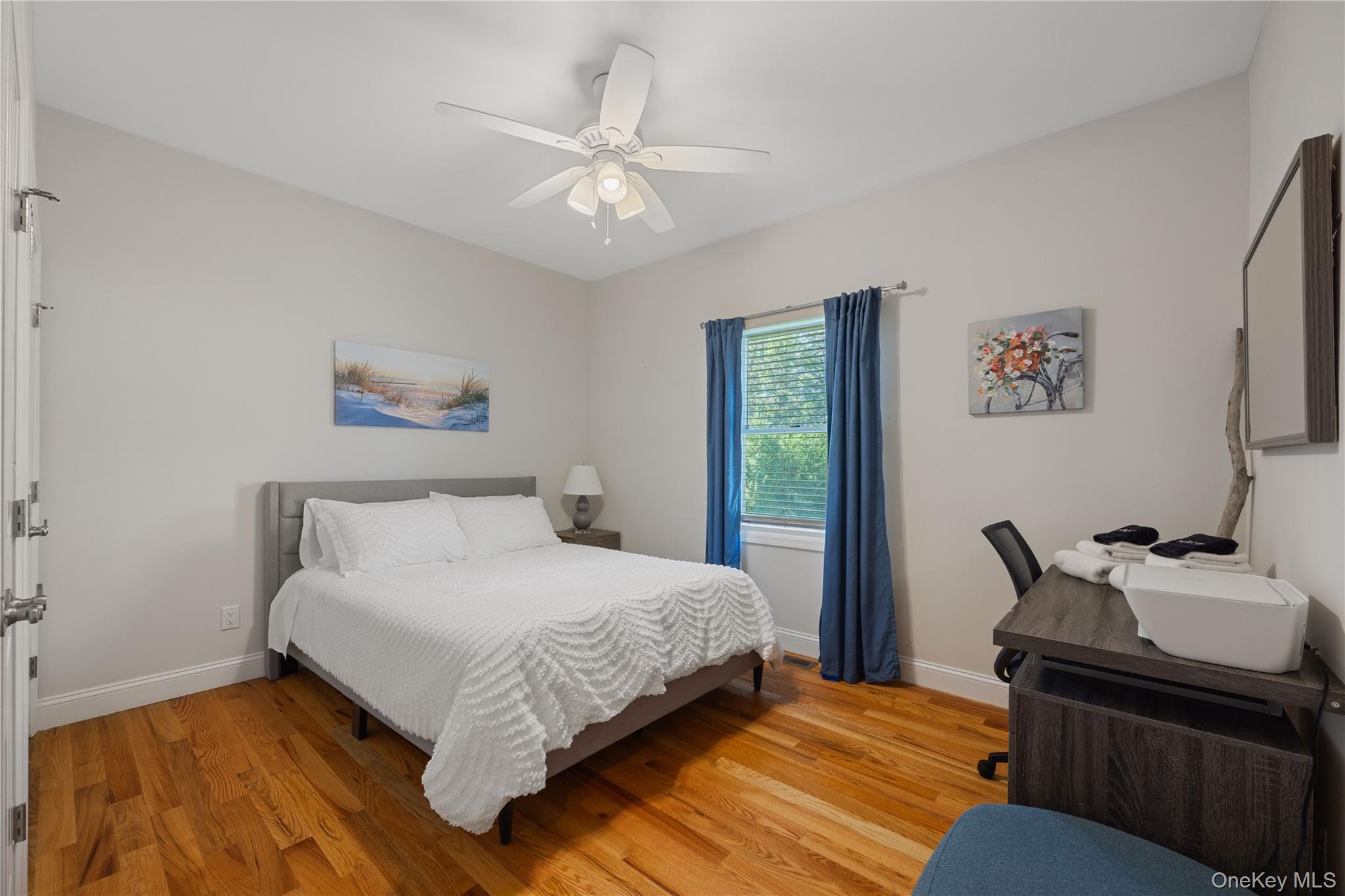380 Homestead Way Greenport, NY 11944 - Photo 17 of 39 a bedroom with a bed and wooden floor