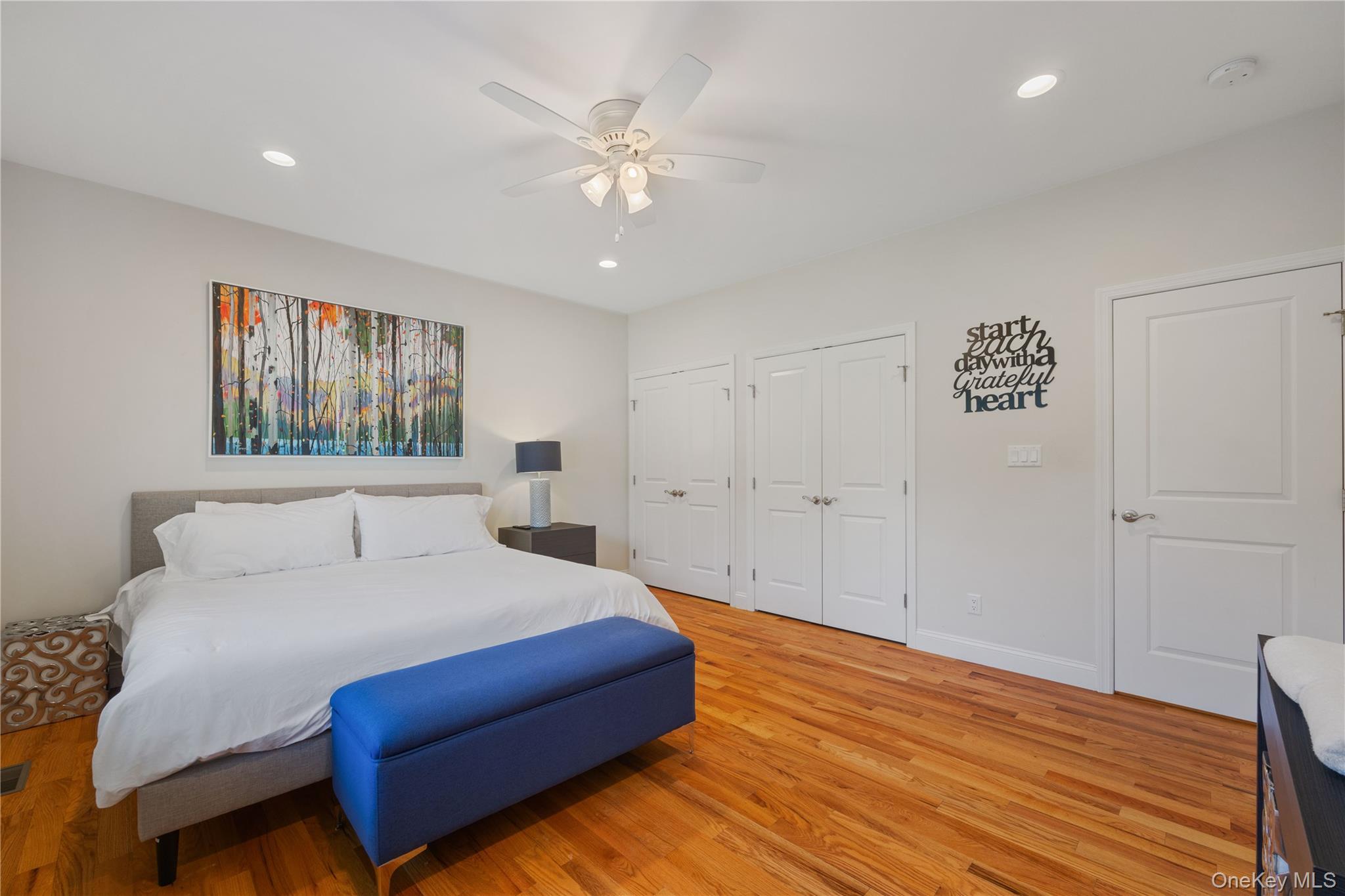 380 Homestead Way Greenport, NY 11944 - Photo 20 of 39 a bedroom with a large bed chandelier and a window