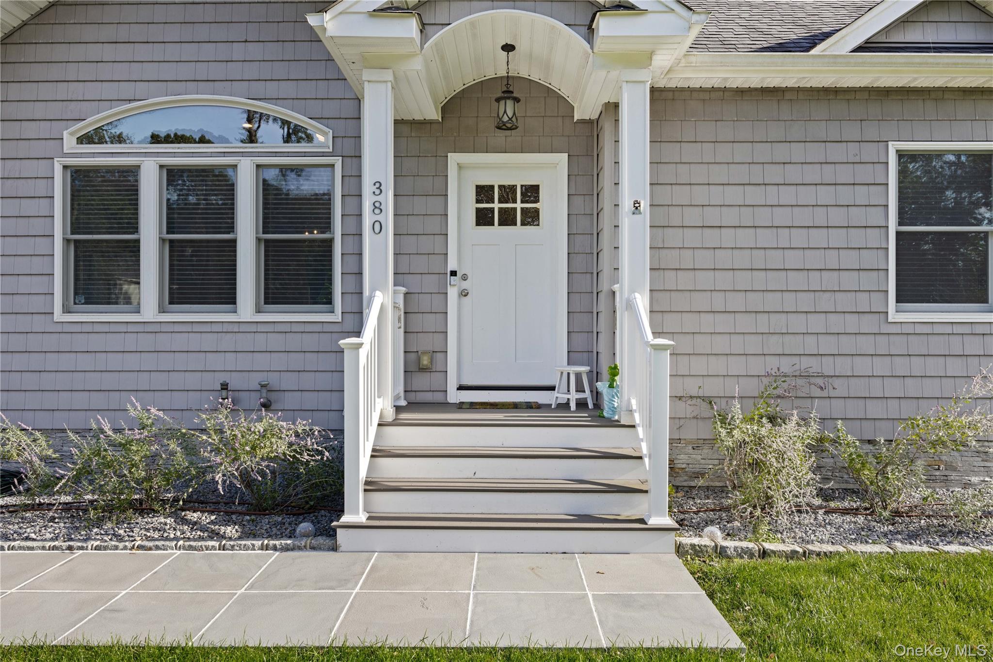 380 Homestead Way Greenport, NY 11944 - Photo 2 of 39 a front view of a house with a yard