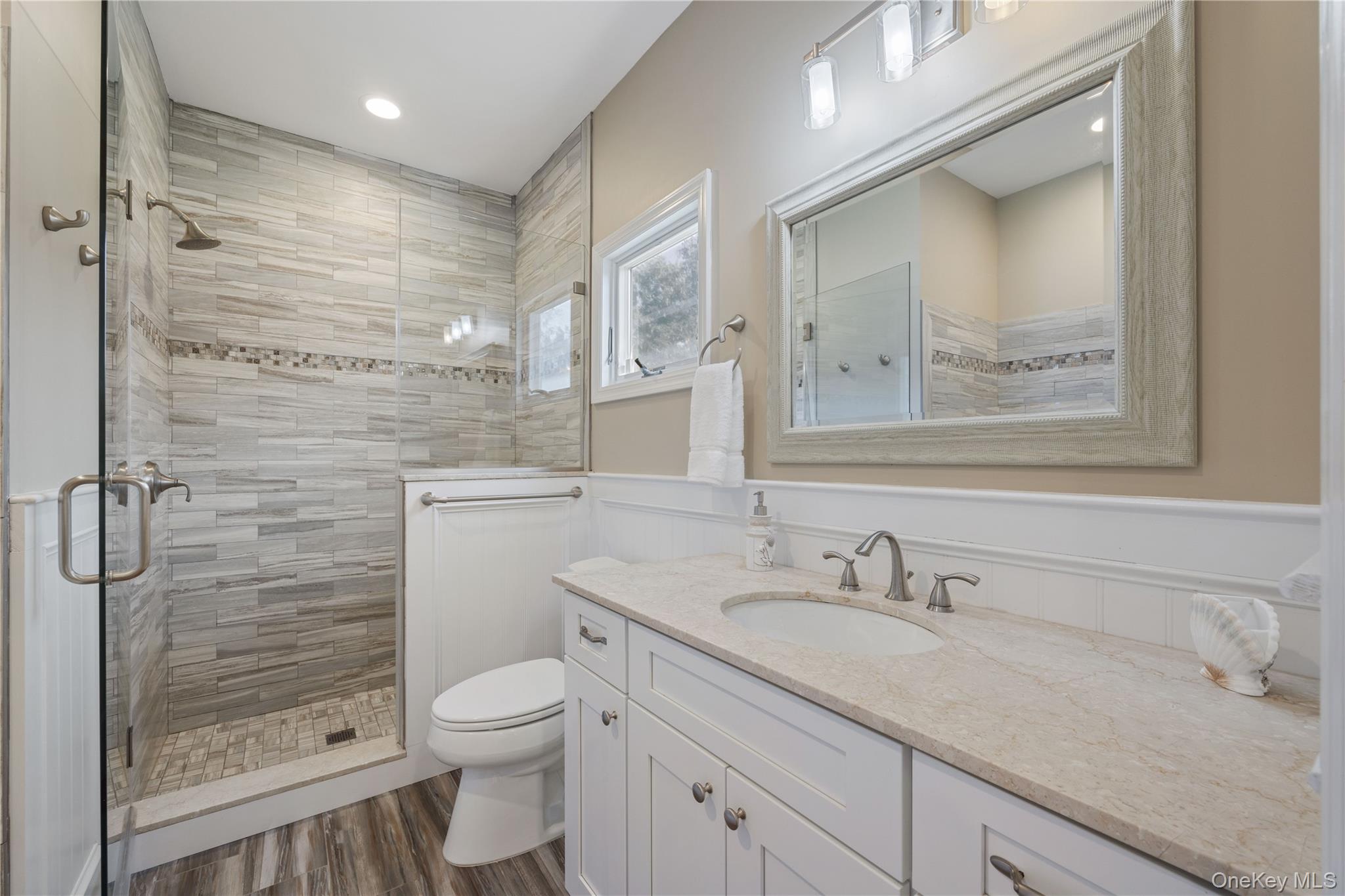 380 Homestead Way Greenport, NY 11944 - Photo 21 of 39 a bathroom with a granite countertop sink a toilet and shower