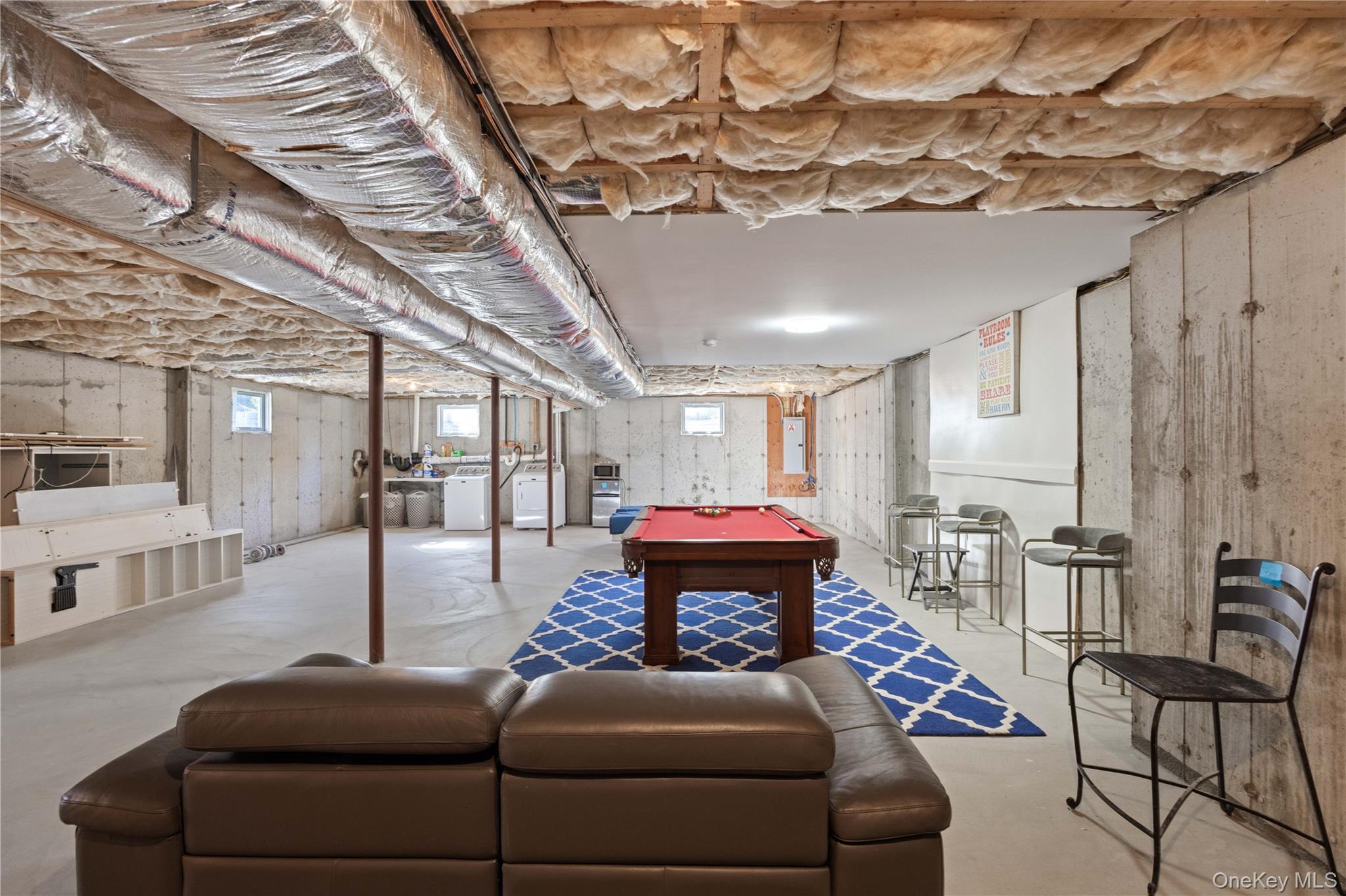 380 Homestead Way Greenport, NY 11944 - Photo 26 of 39 a living room with furniture and a chandelier