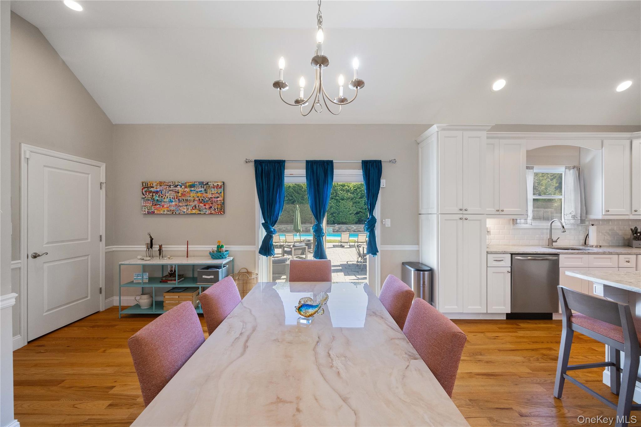 380 Homestead Way Greenport, NY 11944 - Photo 29 of 39 a living room with kitchen island furniture and a chandelier