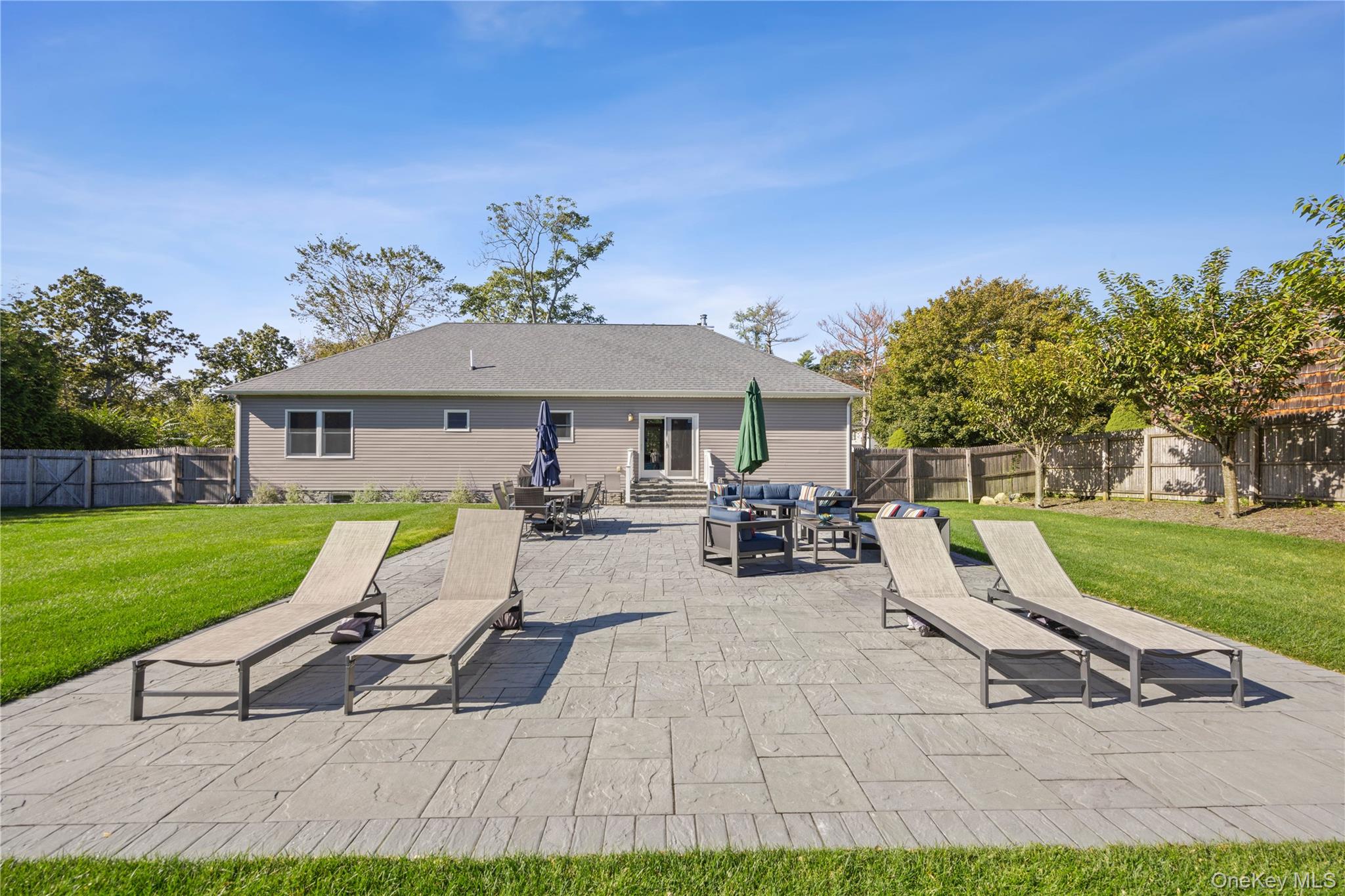 380 Homestead Way Greenport, NY 11944 - Photo 31 of 39 a view of a house with backyard porch and sitting area
