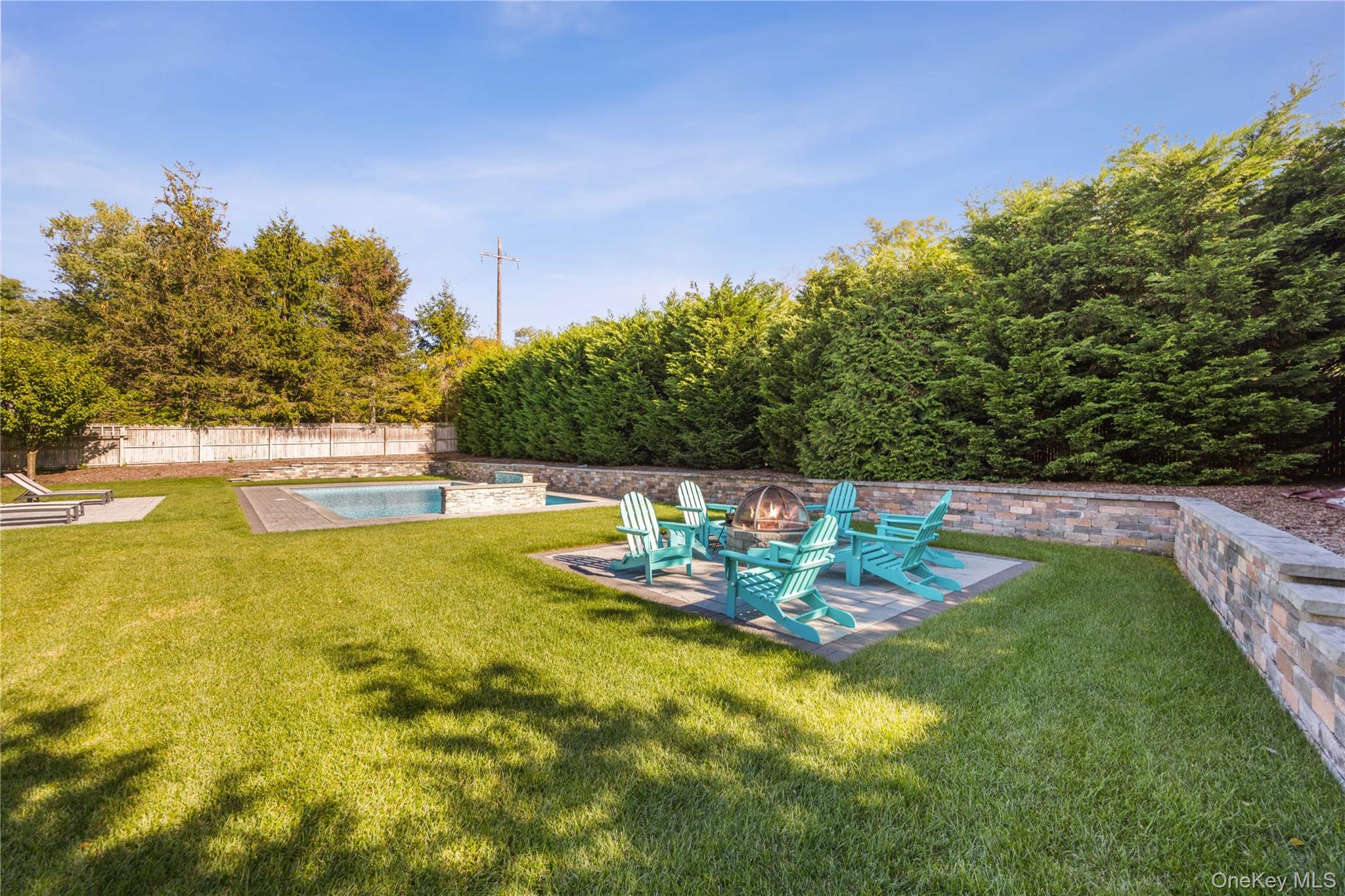 380 Homestead Way Greenport, NY 11944 - Photo 32 of 39 a view of a swimming pool with an outdoor seating and yard