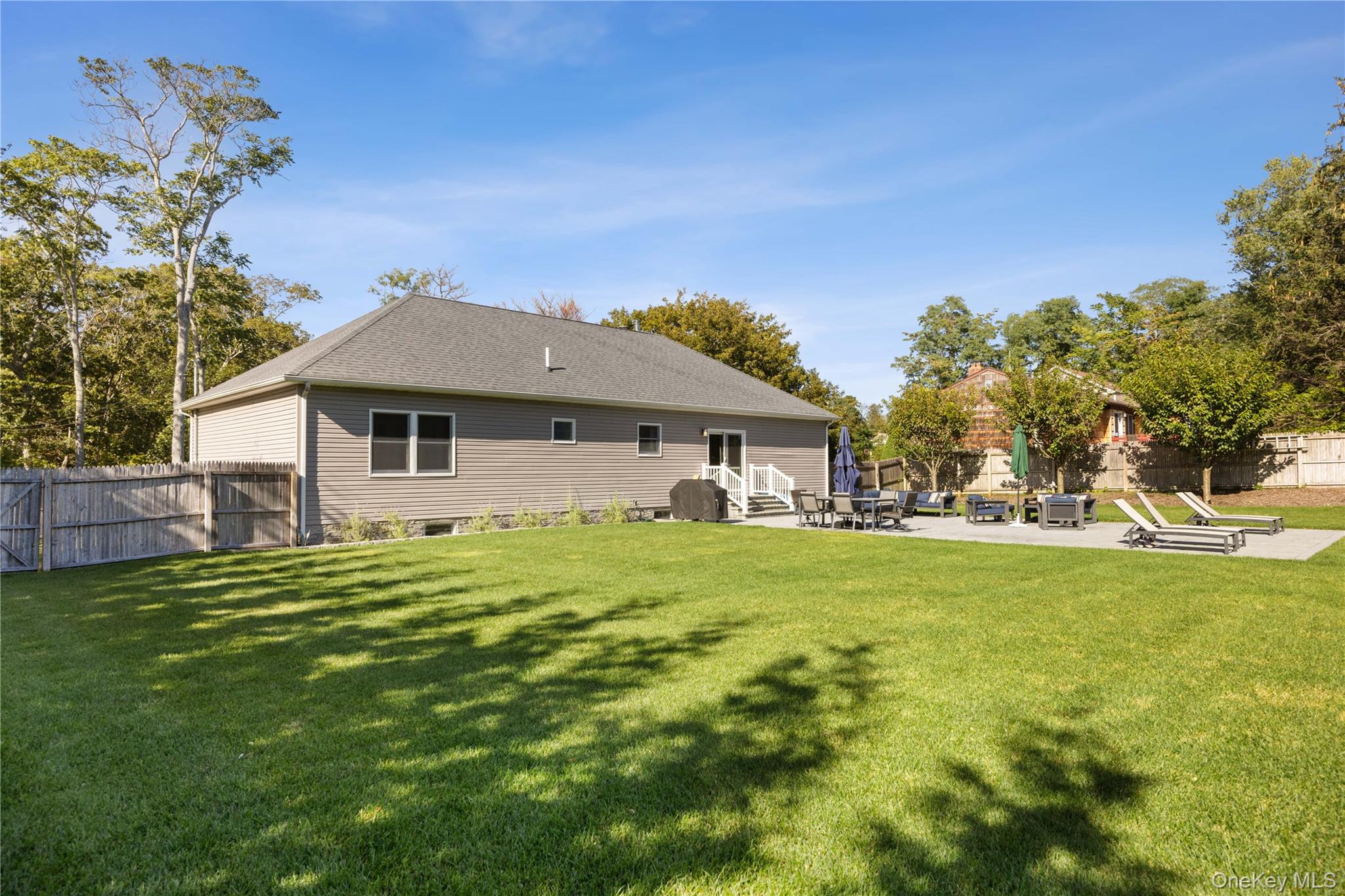 380 Homestead Way Greenport, NY 11944 - Photo 33 of 39 a front view of a house with a garden