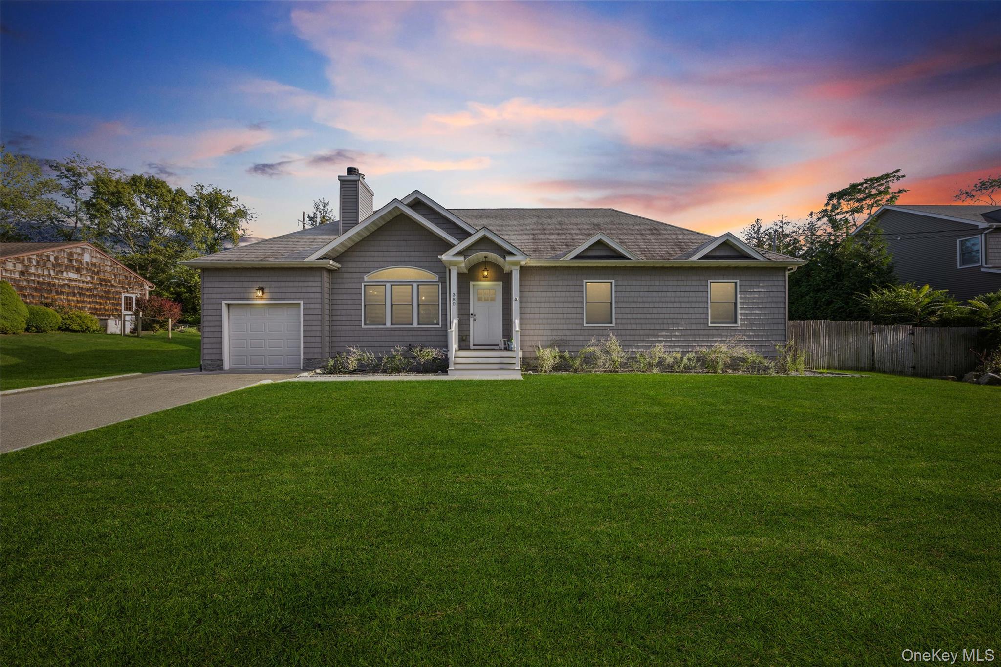 380 Homestead Way Greenport, NY 11944 - Photo 39 of 39 a front view of a house with a garden and yard