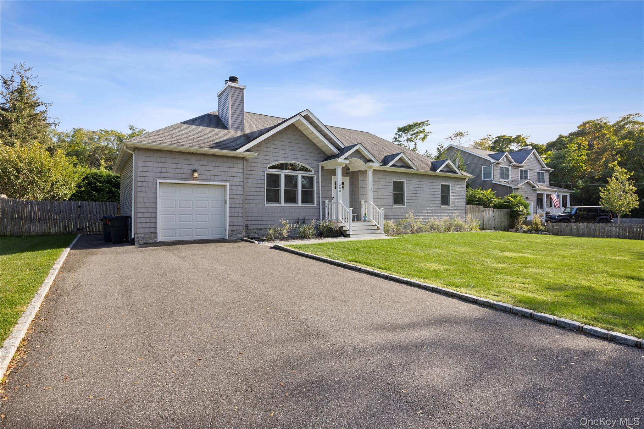 380 Homestead Way Greenport, NY 11944 - Photo 4 of 39 a view of an house with a yard and palm trees