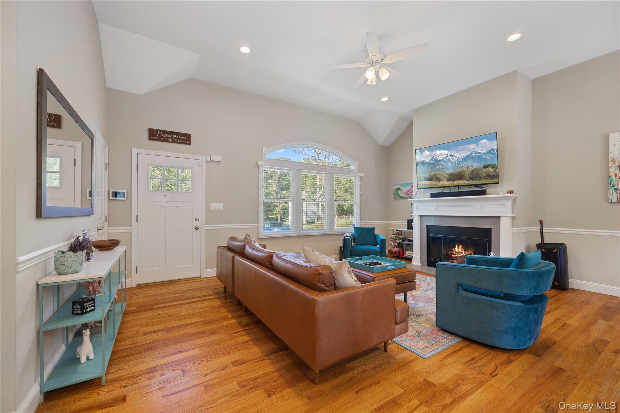 380 Homestead Way Greenport, NY 11944 - Photo 5 of 39 a living room with furniture a fireplace and a large window
