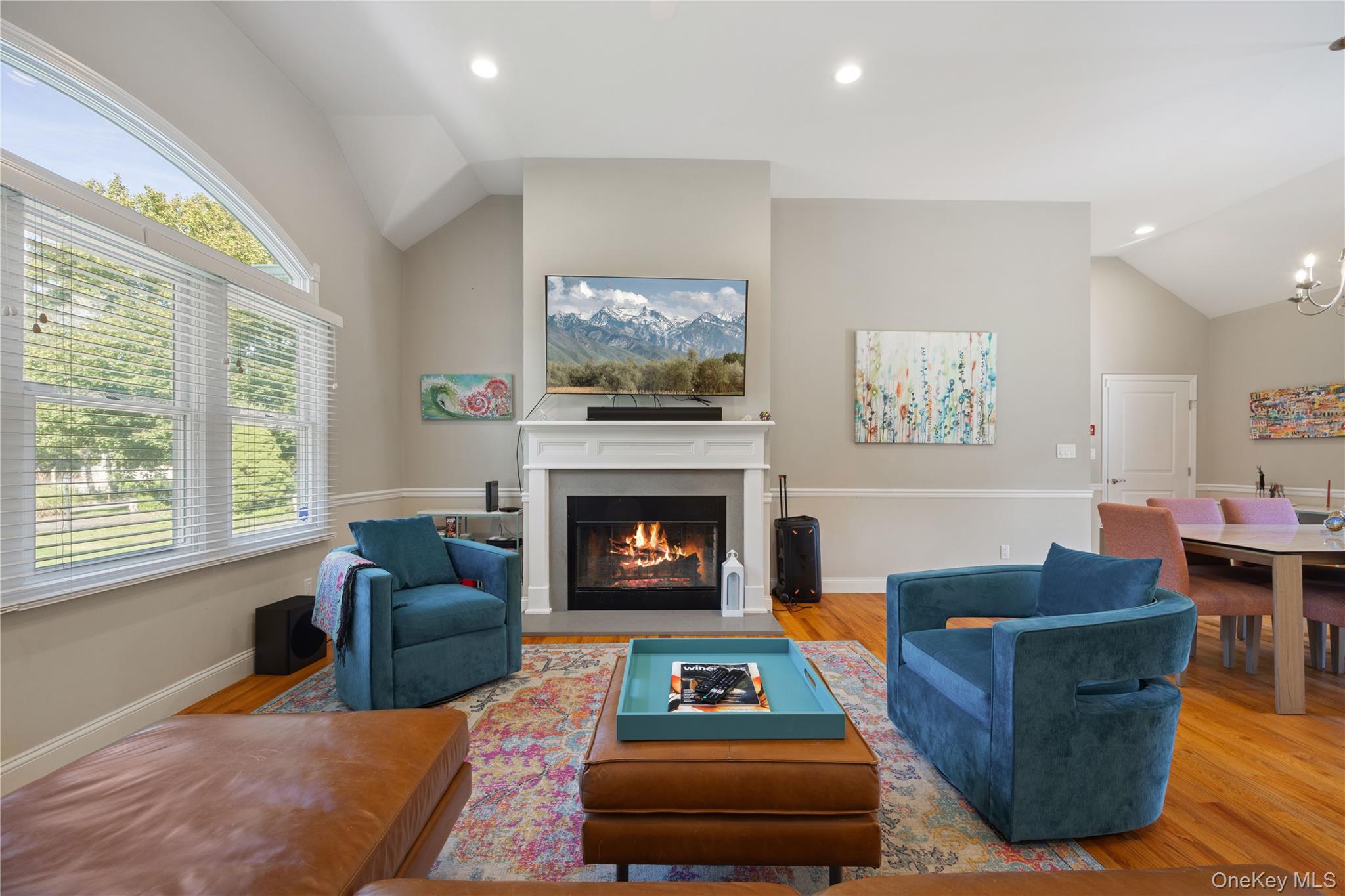 380 Homestead Way Greenport, NY 11944 - Photo 7 of 39 a living room with furniture a flat screen tv and a fireplace