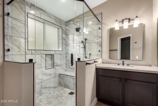 a bathroom with a double vanity sink mirror and shower