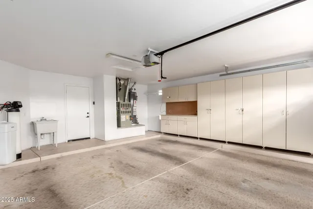 a view of a kitchen with a sink and a refrigerator