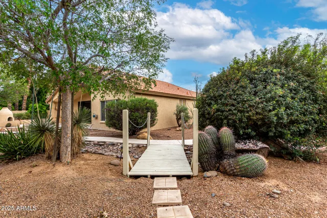 a view of a patio with table and chairs with wooden fence and plants