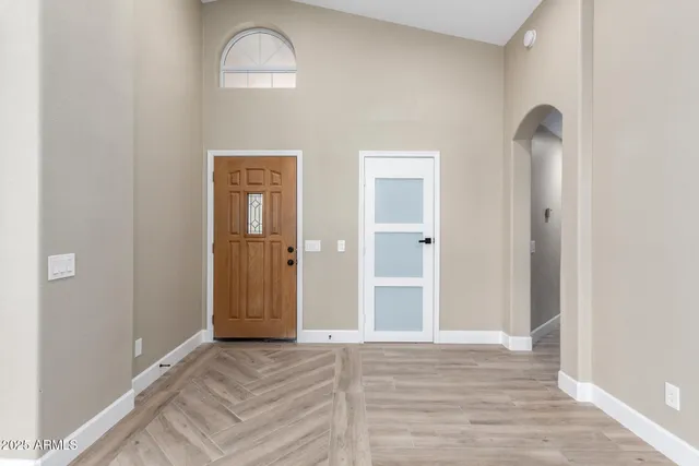 a view of a livingroom with wooden floor and a window