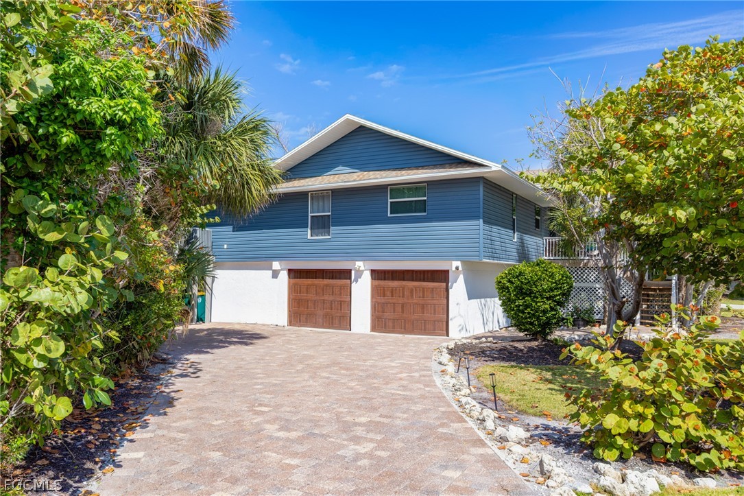 1813 Long Point Lane Sanibel, FL 33957 - Photo 1 of 38 a front view of a house with a yard