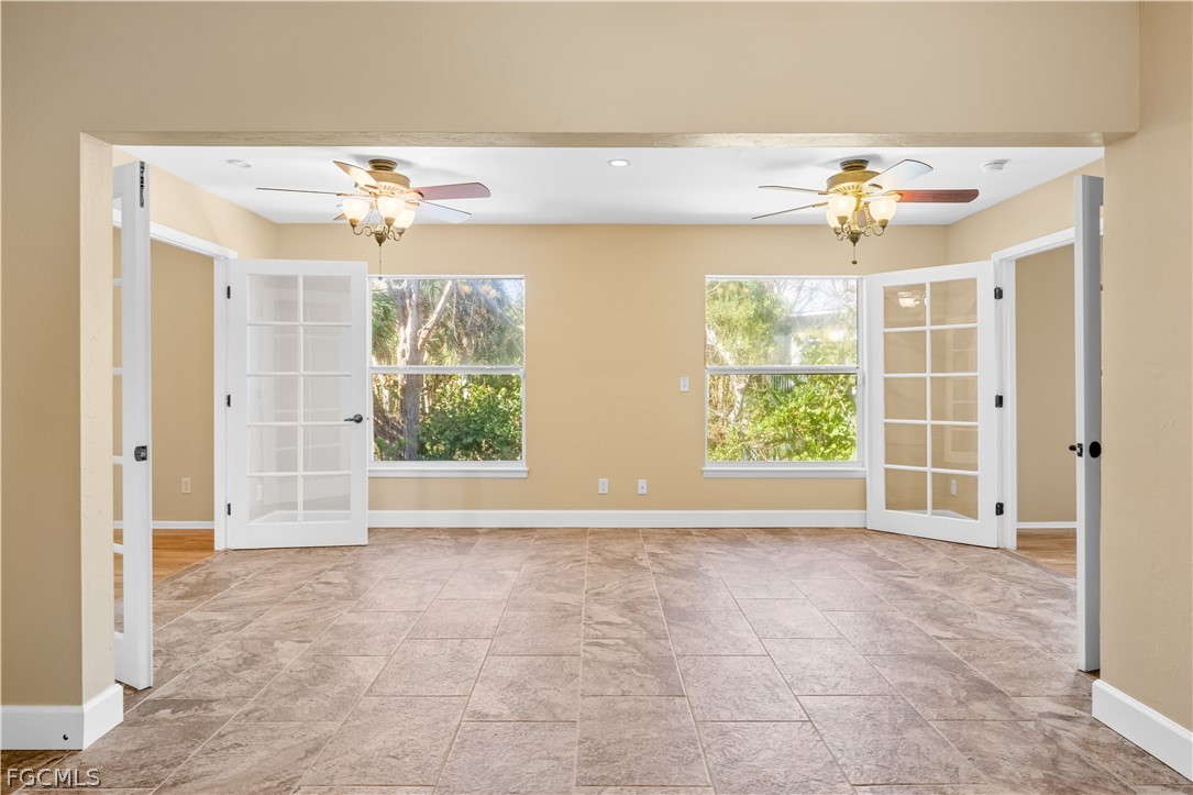 1813 Long Point Lane Sanibel, FL 33957 - Photo 11 of 38 wooden floor in an empty room with a window