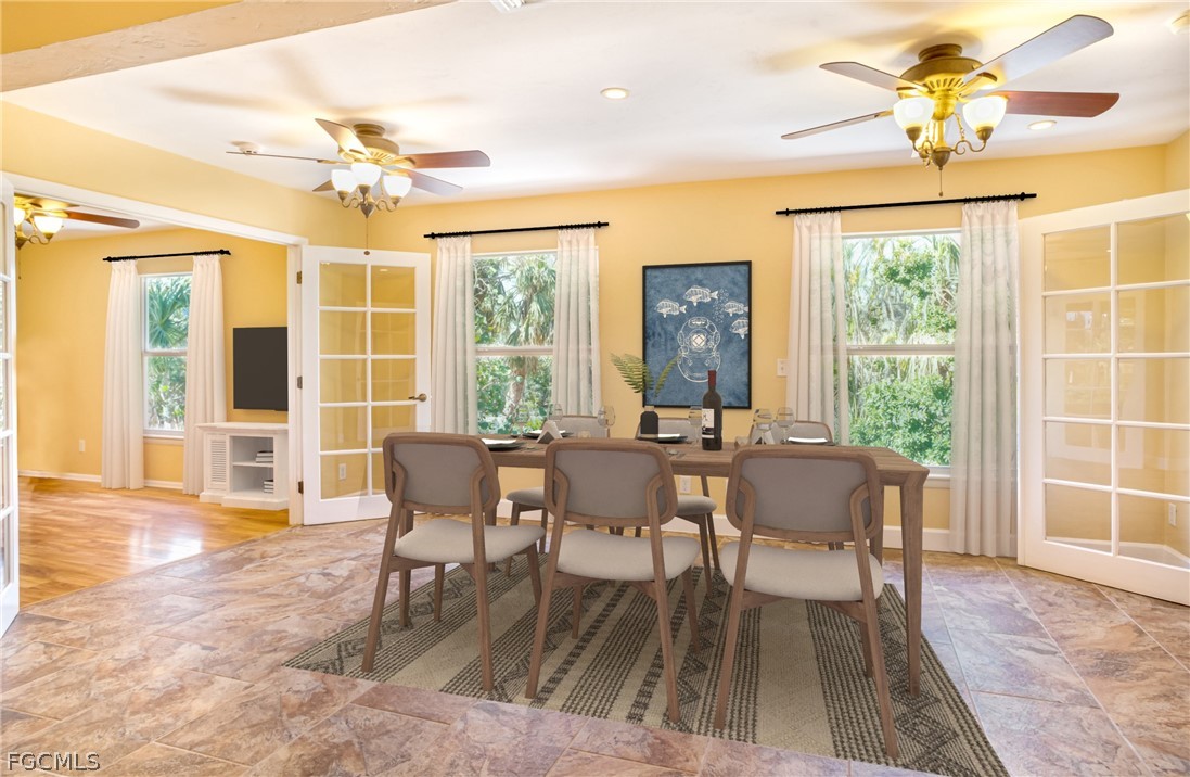 1813 Long Point Lane Sanibel, FL 33957 - Photo 12 of 38 a dining room with wooden floor a chandelier a wooden table and chairs