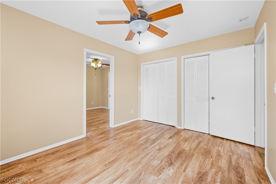 1813 Long Point Lane Sanibel, FL 33957 - Photo 14 of 38 an empty room with wooden floor fan and windows