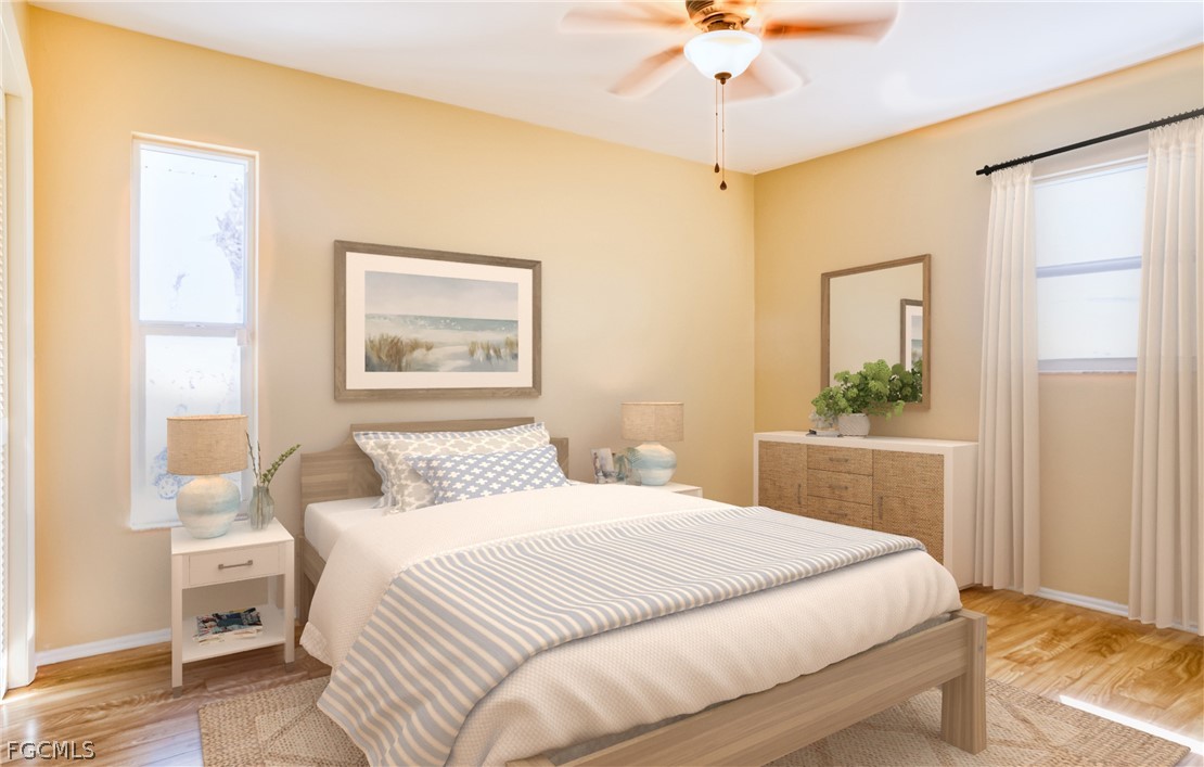 1813 Long Point Lane Sanibel, FL 33957 - Photo 19 of 38 a bedroom with a large bed and a chandelier