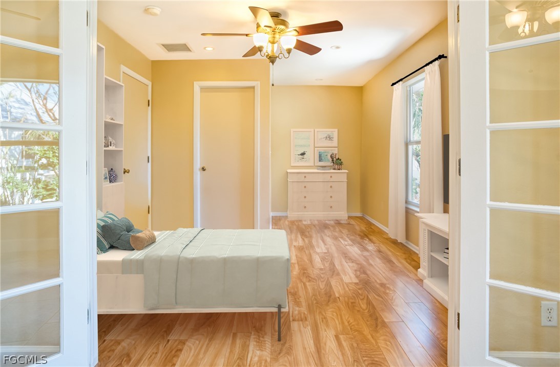 1813 Long Point Lane Sanibel, FL 33957 - Photo 21 of 38 a bedroom with a bed dresser and a window