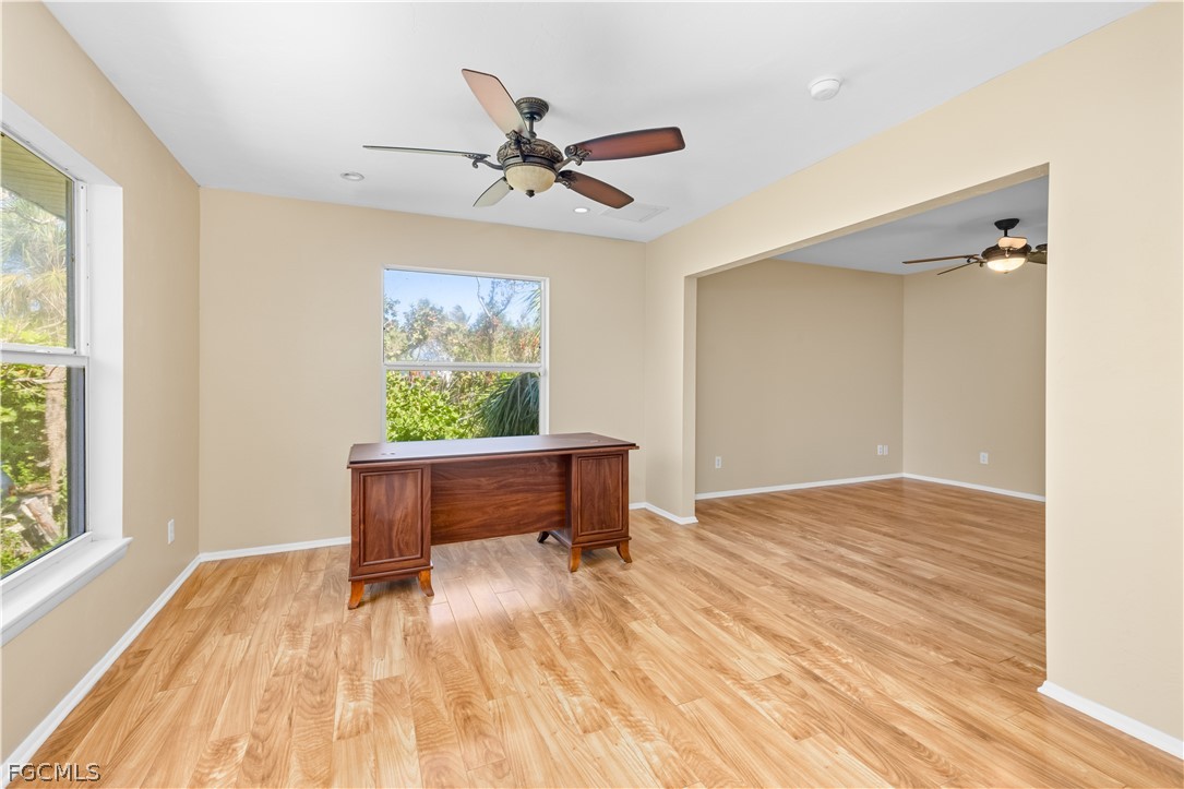 1813 Long Point Lane Sanibel, FL 33957 - Photo 23 of 38 a view of a livingroom with wooden floor and a ceiling fan