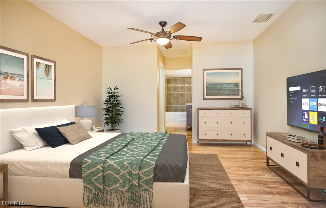 1813 Long Point Lane Sanibel, FL 33957 - Photo 27 of 38 a bedroom with a large bed and a chandelier