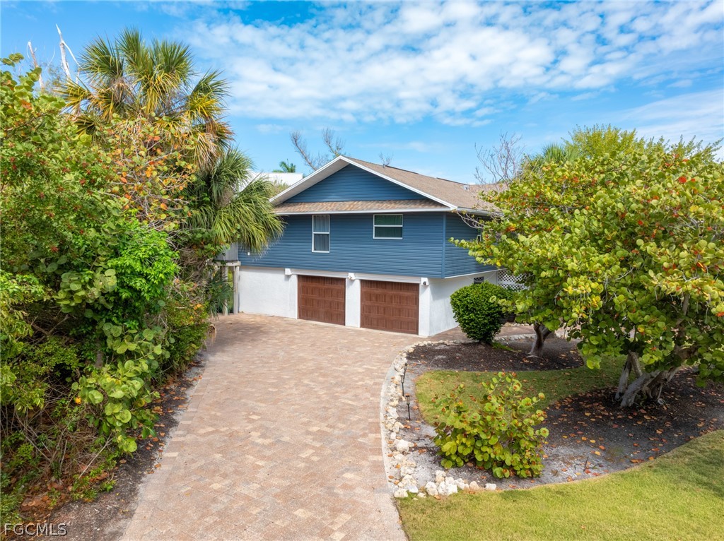 1813 Long Point Lane Sanibel, FL 33957 - Photo 31 of 38 a front view of a house with a yard