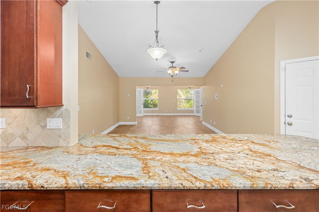1813 Long Point Lane Sanibel, FL 33957 - Photo 5 of 38 a view of a kitchen with granite countertop cabinets and wooden floor