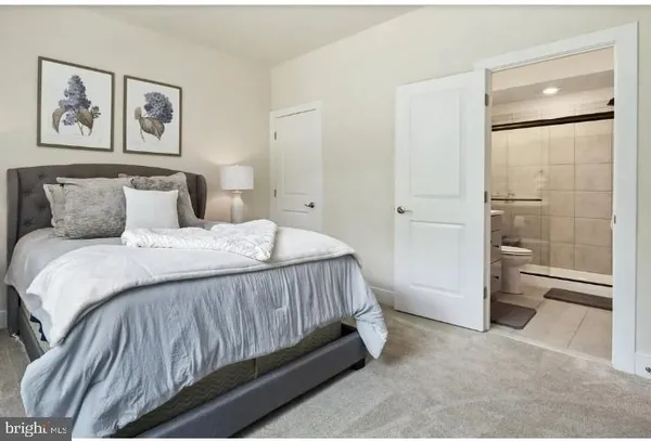 a bedroom with a bed and a painting on the wall