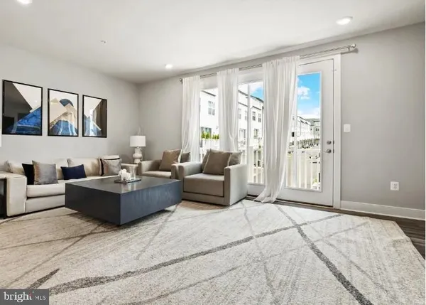 a living room with furniture and large windows