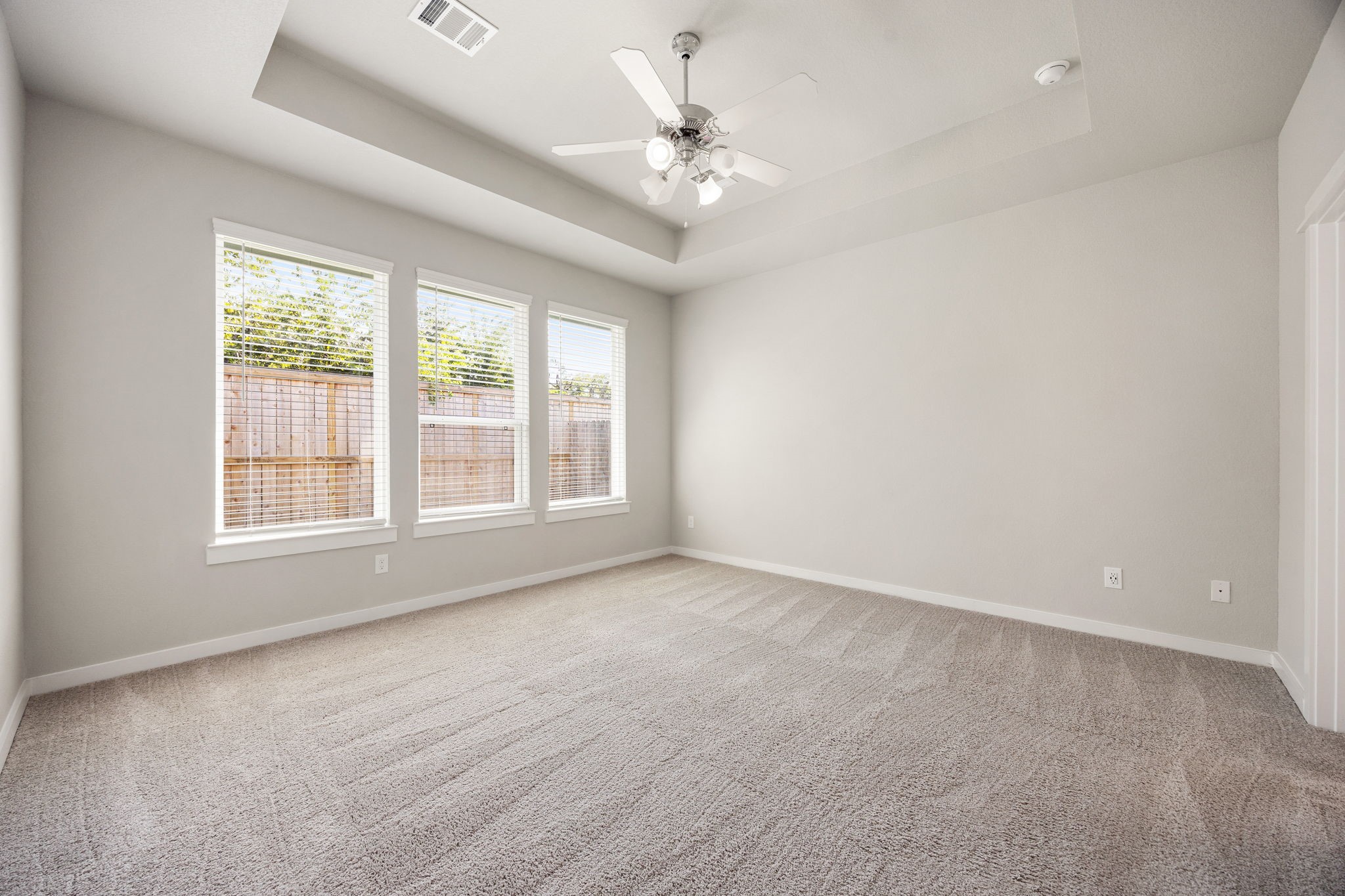 33007 Carolyns Perfection Loop Fulshear, TX 77441 - Photo 3 of 31 Primary bedroom with tray ceilings
