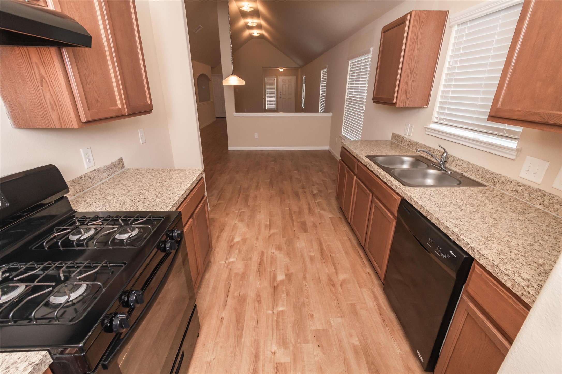 2442 Jonahs Way Houston, TX 77073 - Photo 6 of 10 a kitchen with wooden cabinets and a stove top oven