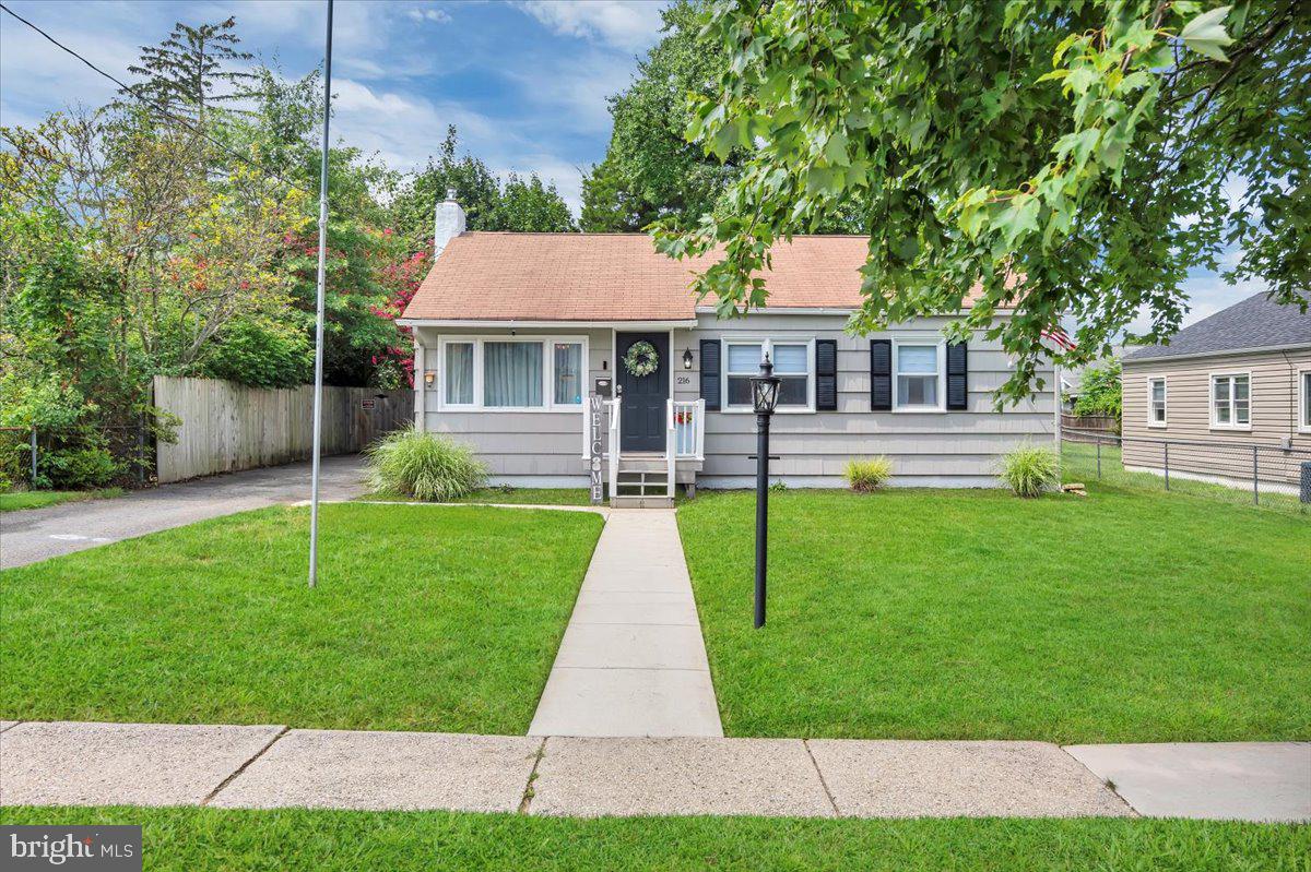 216 Evergreen Avenue Mantua, NJ 08051 - Photo 1 of 30 a front view of a house with a yard and potted plants