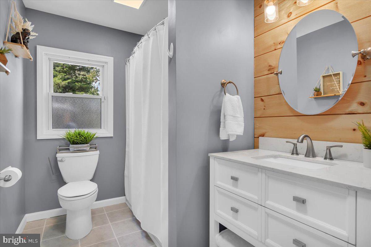 216 Evergreen Avenue Mantua, NJ 08051 - Photo 12 of 30 a bathroom with a toilet sink and mirror
