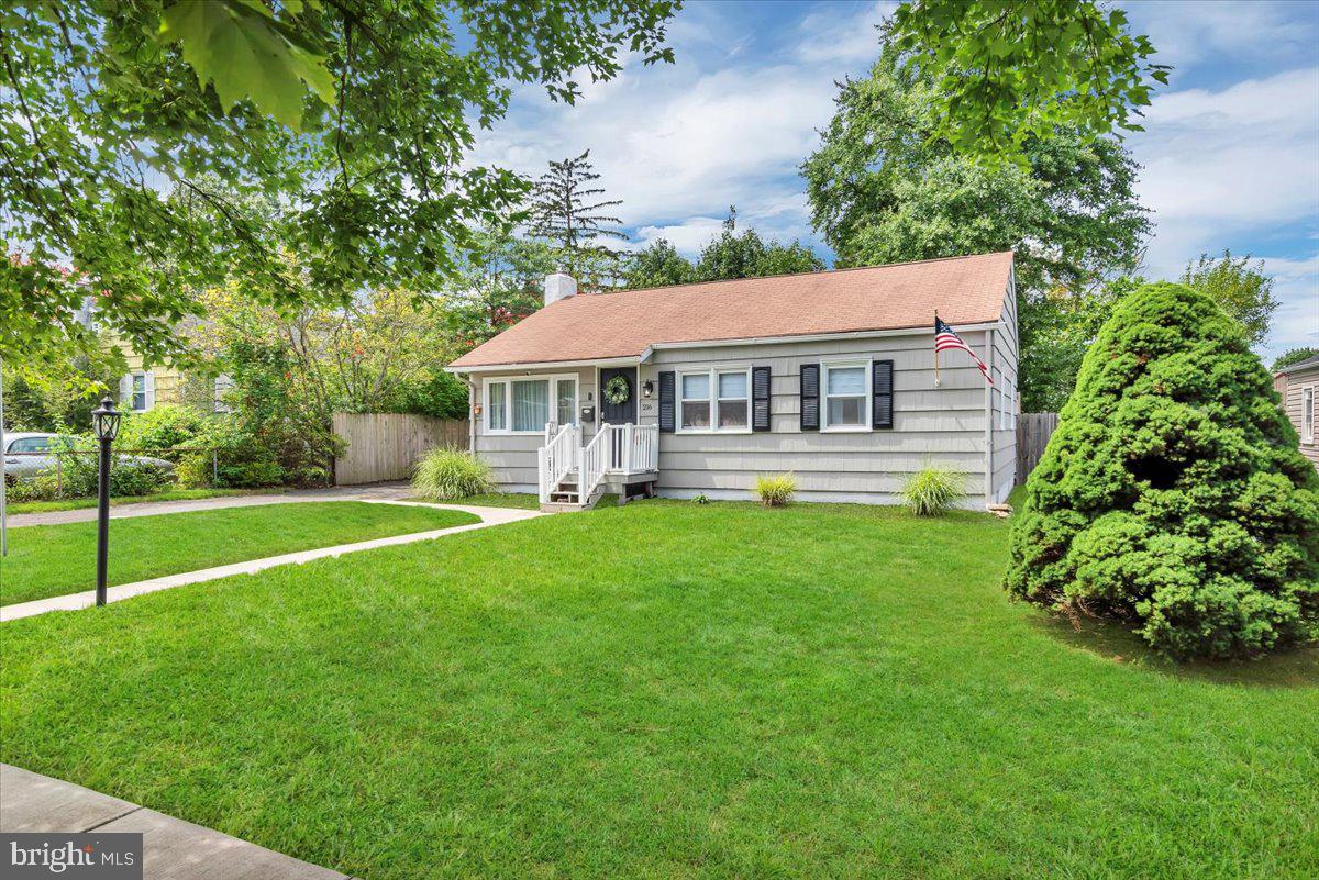 216 Evergreen Avenue Mantua, NJ 08051 - Photo 2 of 30 a front view of a house with a yard table and chairs