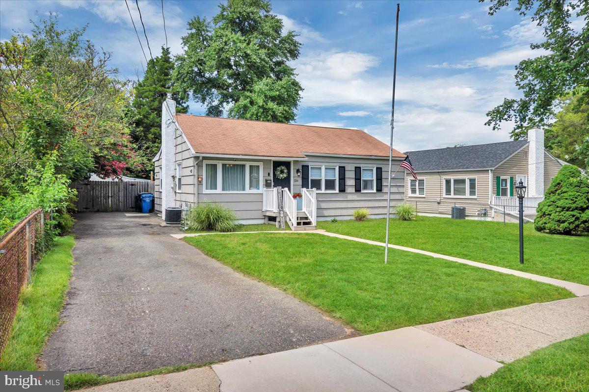 216 Evergreen Avenue Mantua, NJ 08051 - Photo 3 of 30 a view of a white house with a yard table and chairs