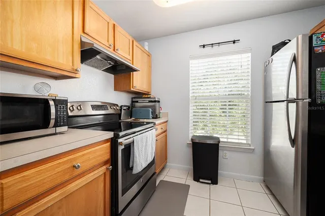 a kitchen with a stove microwave and refrigerator